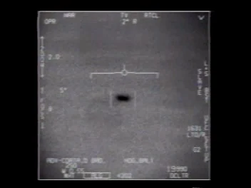 Pantalla del pod en modo TV: una forma oscura y alargada en el centro sobre fondo gris.